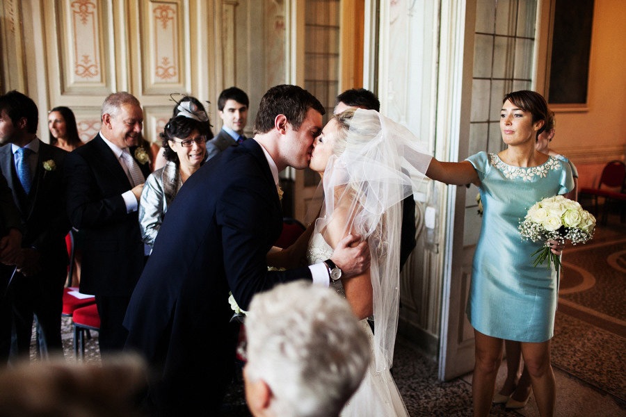 groom kissing bride, mother crying