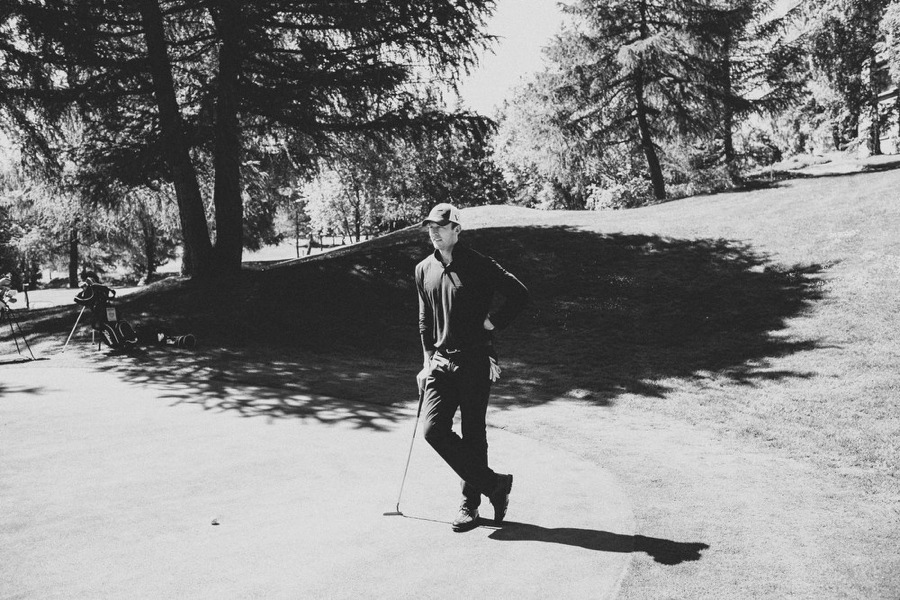 groom playing golf before his wedding