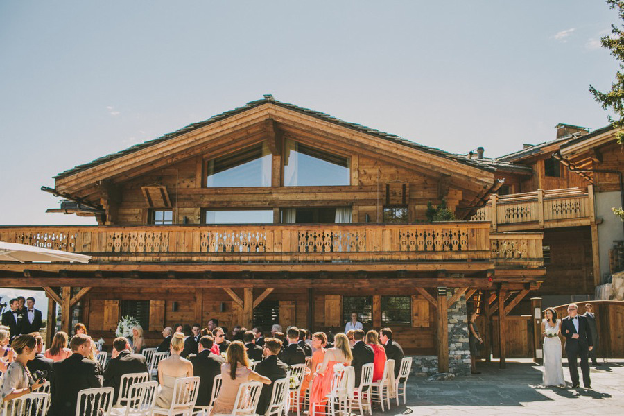 bride and her father walking down the isle for the wedding at LeCrans Hotel in Crans-Montana