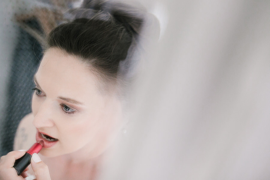 bride doing her makeup before wedding