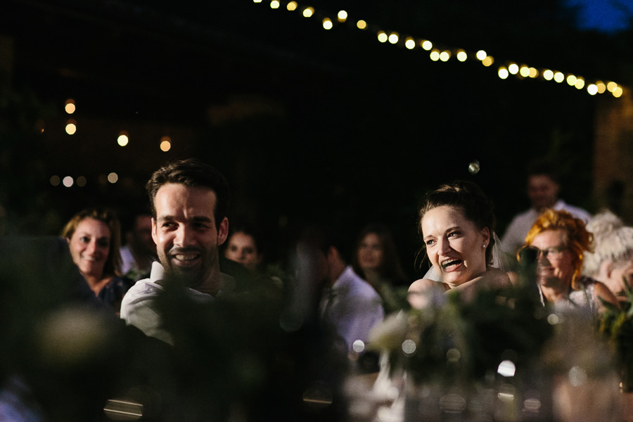 bride and groom listening to wedding speech