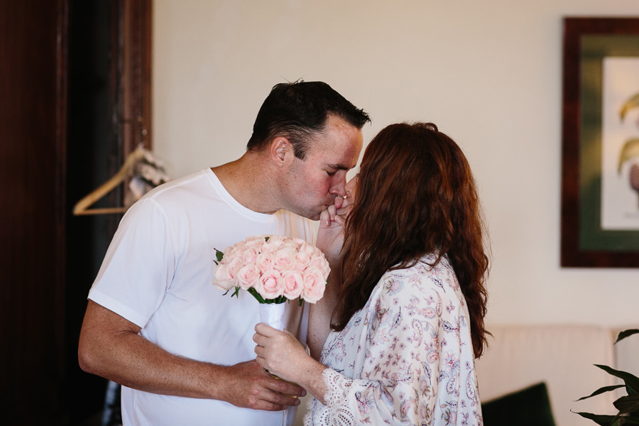 groom kissing bride’s hand