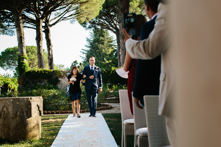 Bride and his mother walking down the aisle