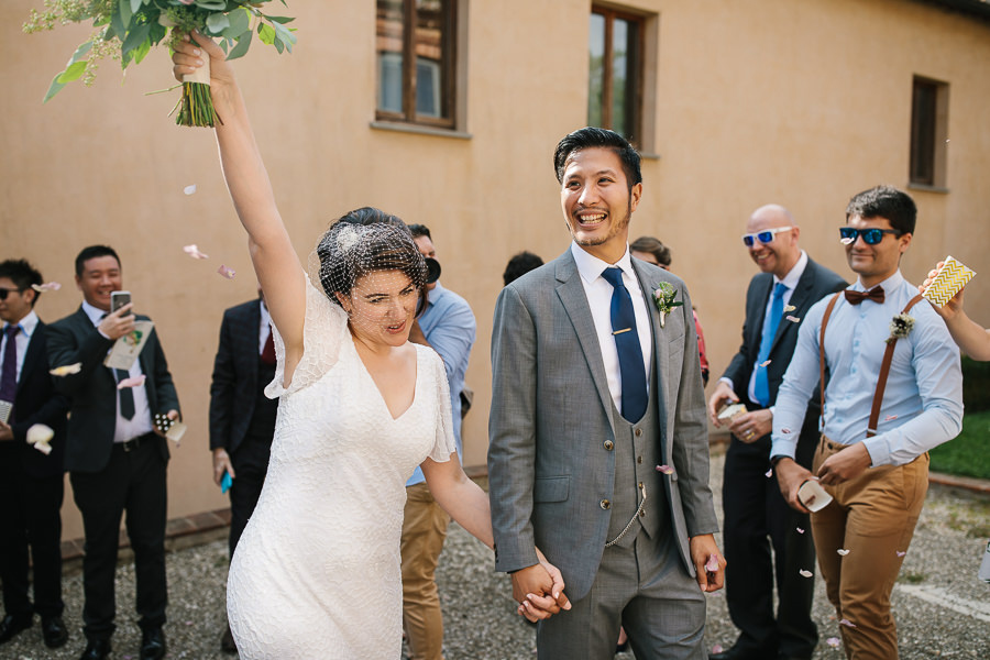 Wedding couple leaving church in Tuscany