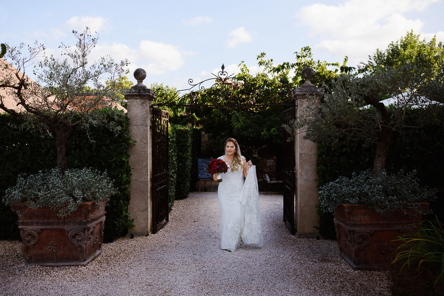 Bride walking down the aisle at Borgo Santo Pietro elopement wed