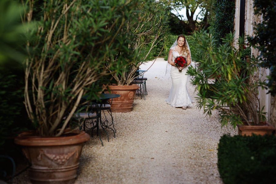 Bride walking down the aisle at Borgo Santo Pietro elopement wed