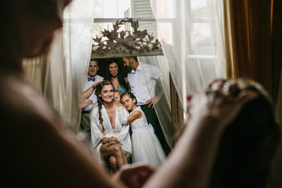 getting ready in front of a mirror with all family members