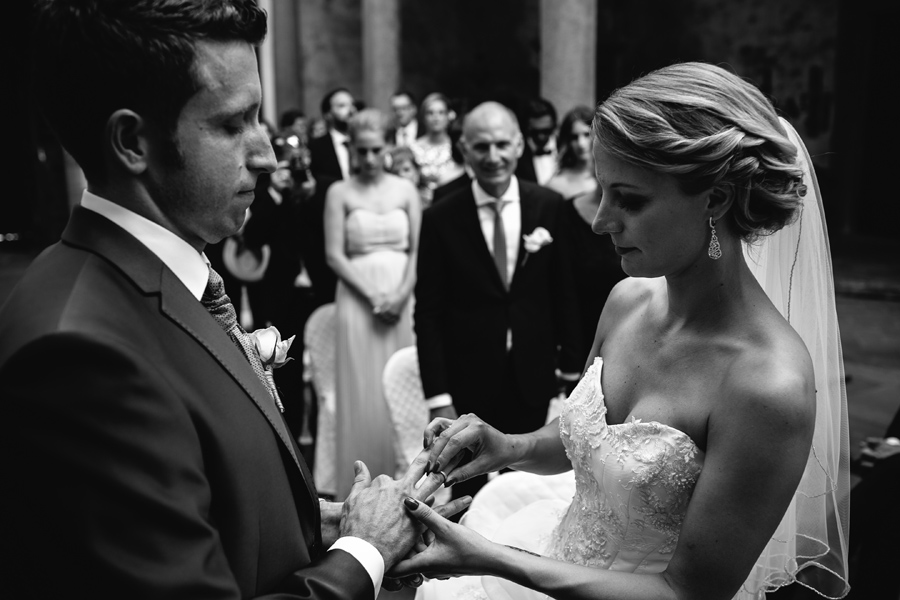 Bride and groom changing rings in Tuscany