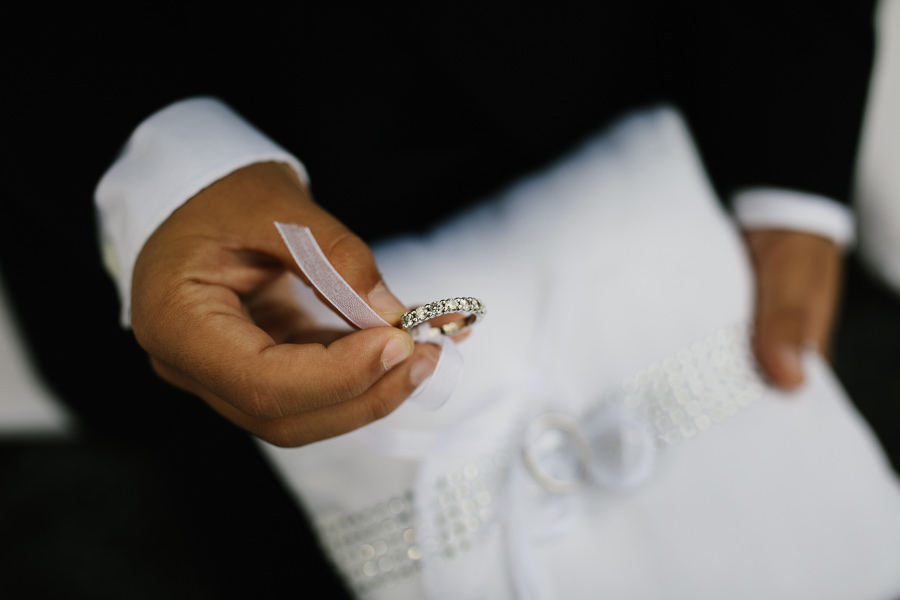 little boy holding wedding rings