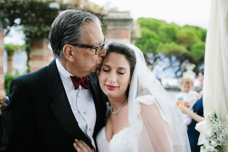 father kissing bride at wedding ceremony at la cervara portofino