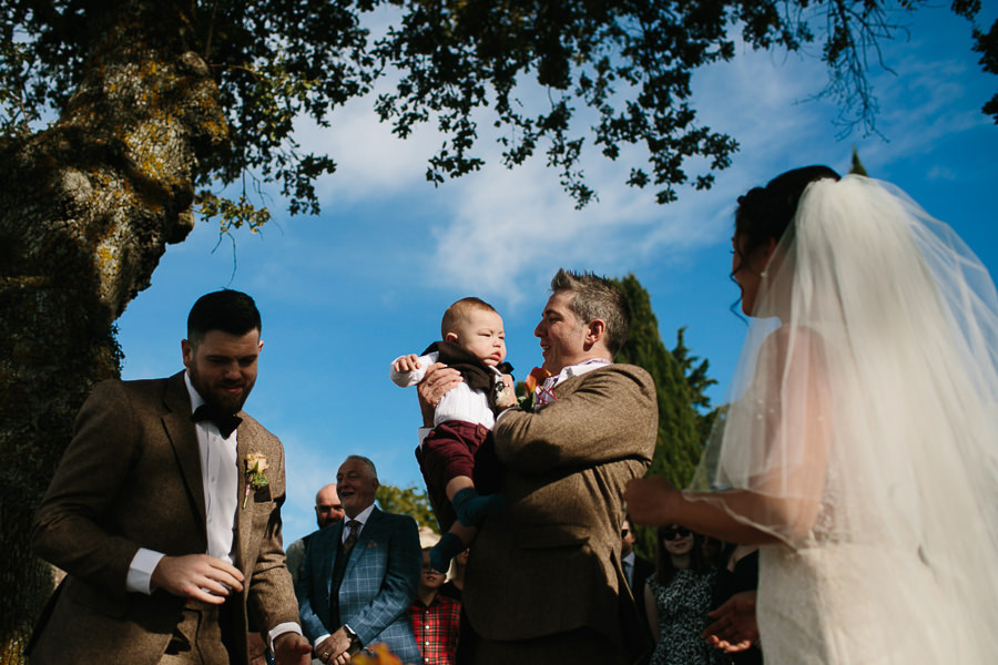 groom holding his little son