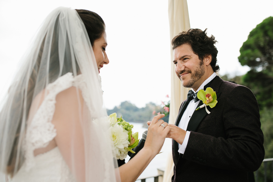 bride putting the wedding ring on