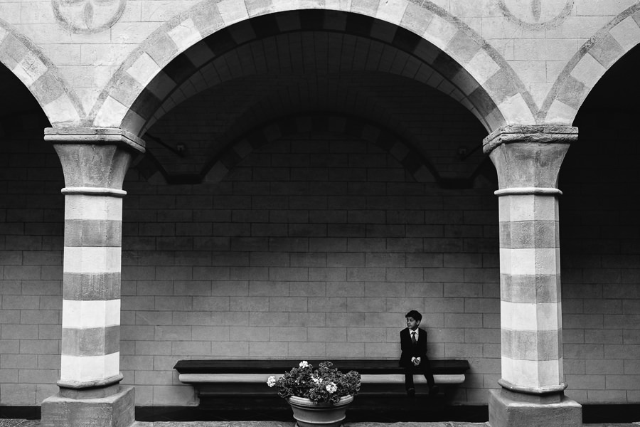 little boy waiting under arcades at la cervara