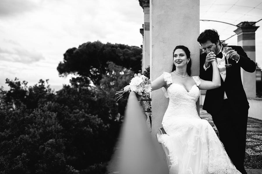 groom kissing bride’s hand