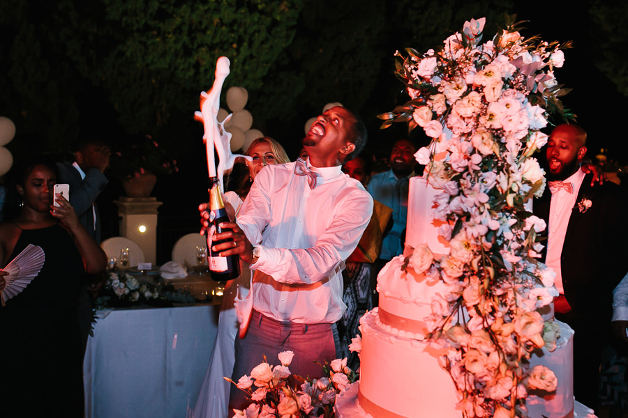 Groom sprays champagne