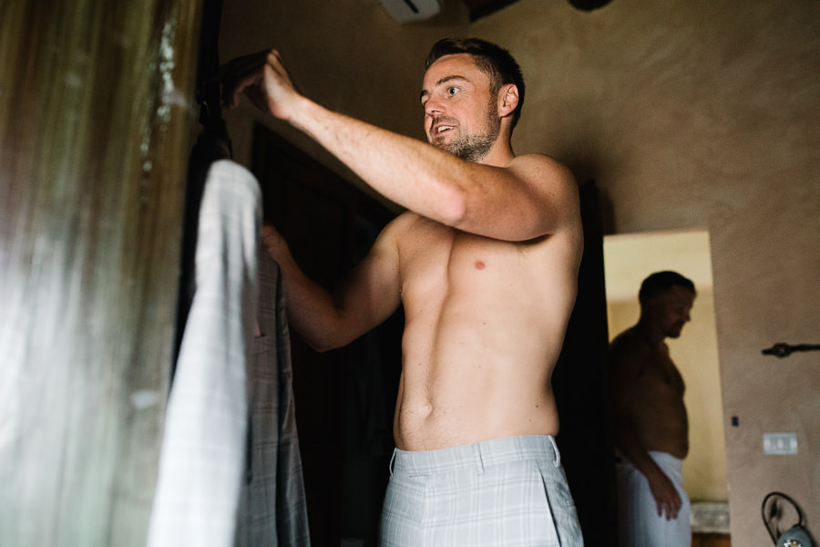 Groom getting ready for wedding at Castello del Trebbio