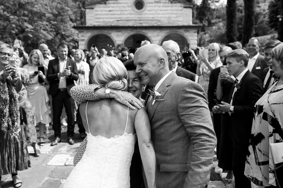 Bride and groom leaving wedding church in Tuscany