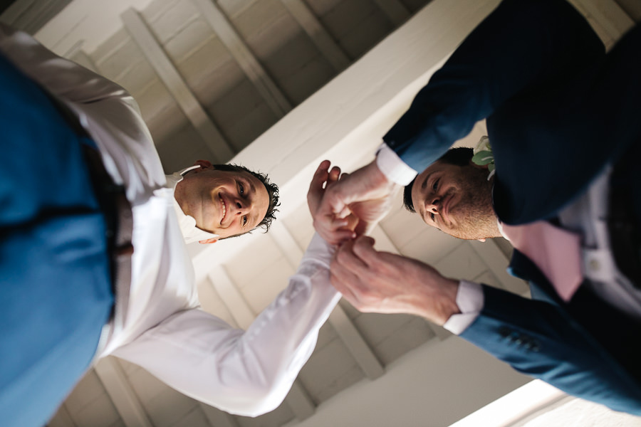 Groom and his best mean getting ready for wedding in tuscany