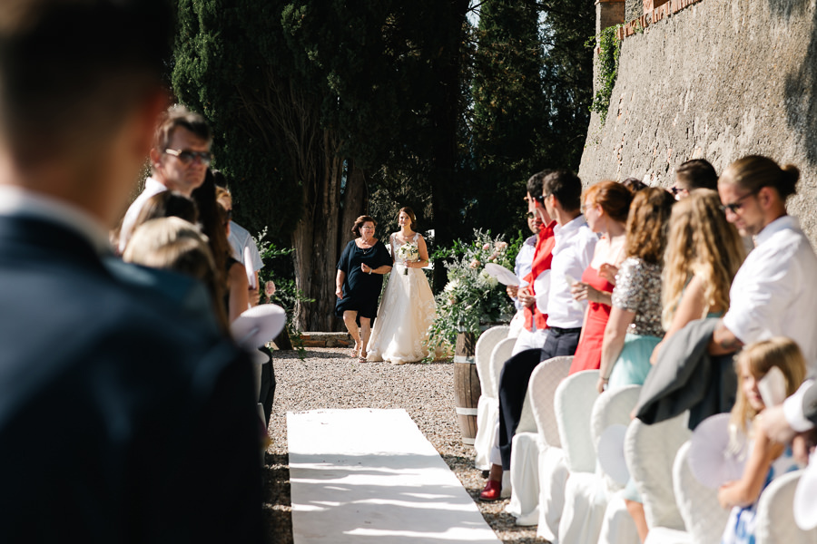 bride putting on her dress for wedding at tenuta mocajo