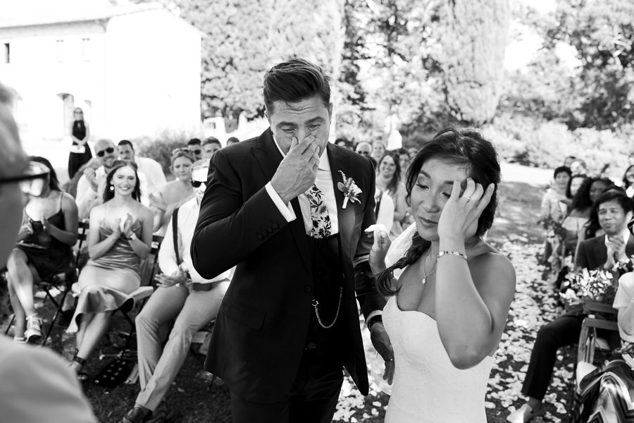 bride and groom are crying during the wedding ceremony