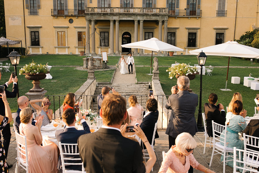 bride and groom walking down the aisle at villa di maiano